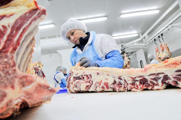 Cutting meat in a meat factory