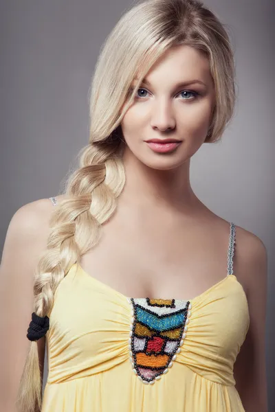 Blonde young woman with braid hairdo