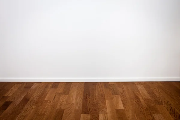 Empty white wall and wooden floor — Stock Photo #38045503