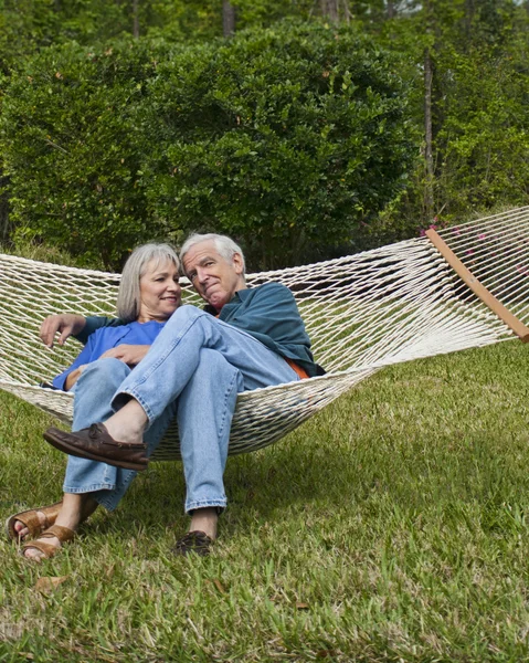 Expressive Senior Couple in Garden Hammock