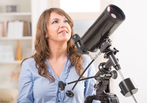 Beautiful woman with astronomical telescope