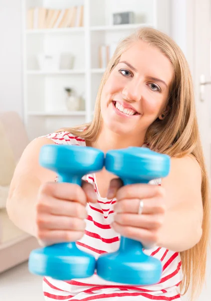 Young woman with dumbbell