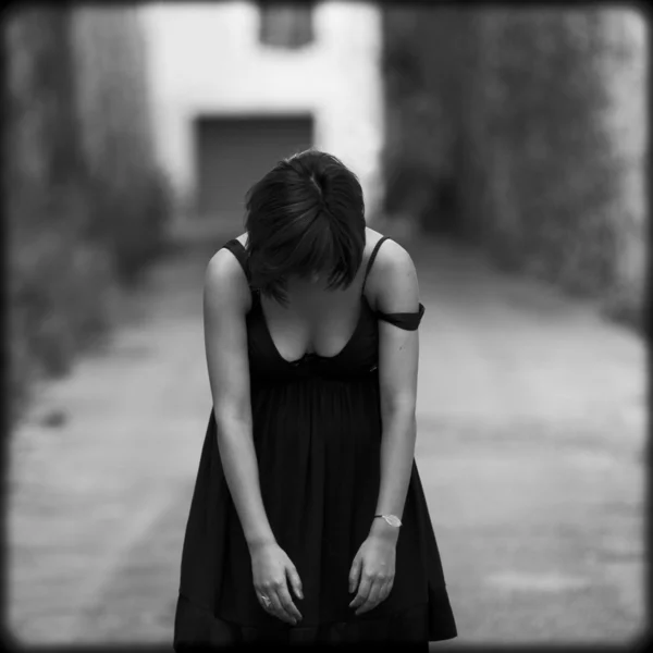 Sad or tired woman standing motionless