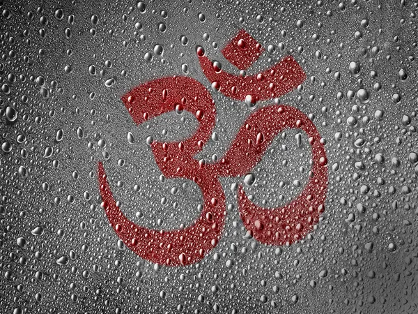 Hindu symbol drawn at metal surface covered with rain drops