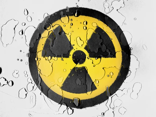 Nuclear radiation symbol painted on covered with water drops