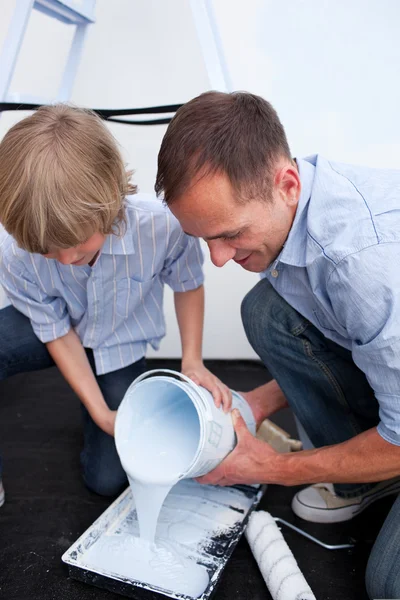 Happy father and his son preparing paint