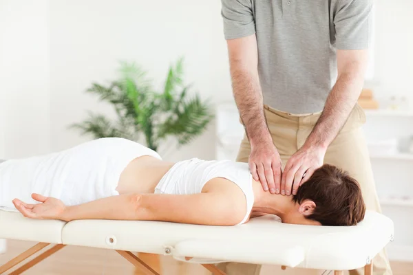 Guy massaging a brunette woman\'s neck