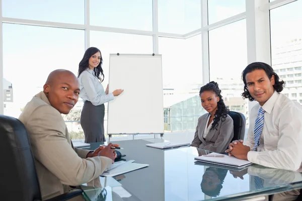 Business team almost smiling in a meeting room during a presenta