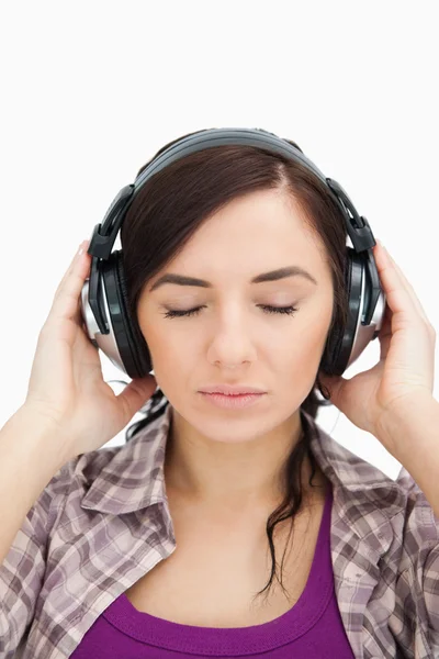Woman with headphones enjoying music the eyes closed