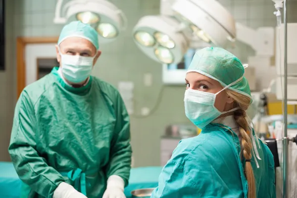 Two surgeon wearing surgical equipment