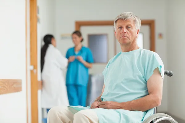 Male patient in a wheelchair looking at camera