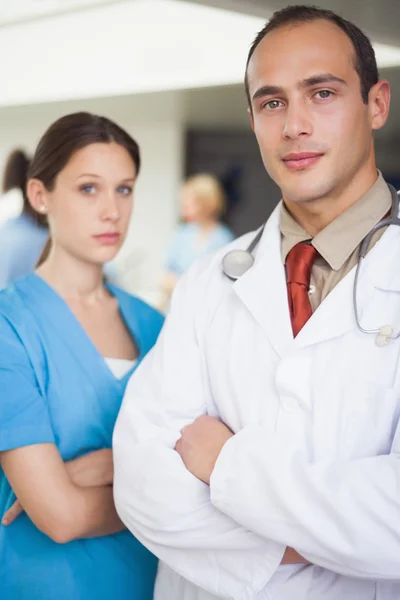 Serious doctor and nurse with arms crossed