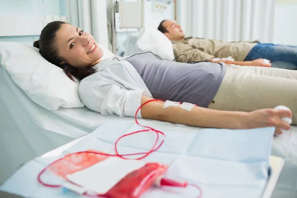 Smiling transfused patient next to another