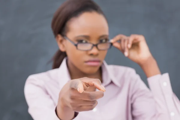 Focus on a strict black teacher pointing finger