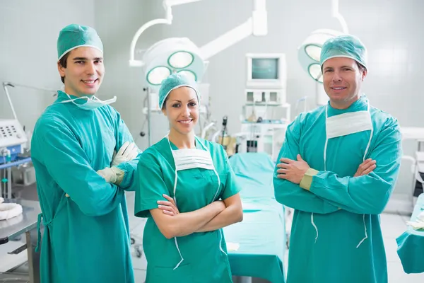 Surgeons standing up with arms crossed