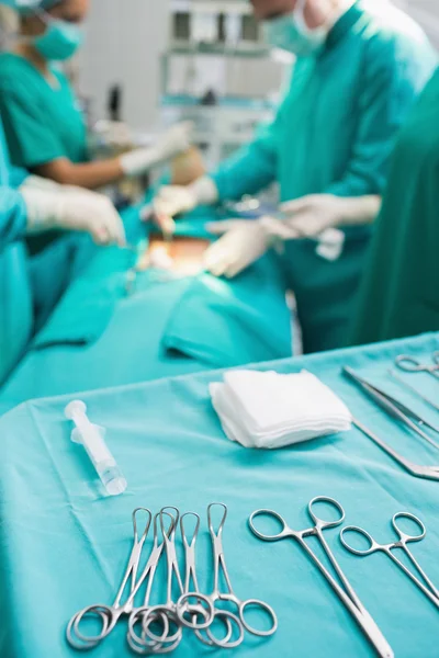 Focus on surgical tools next to operating table