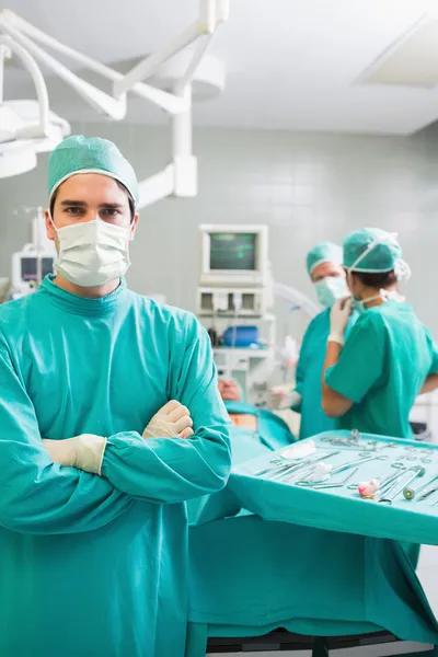 Surgeon looking at camera with arms crossed