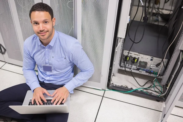 Man smiling while doing server maintenance