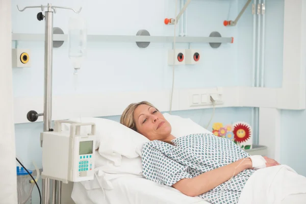 Female patient lying in hospital bed