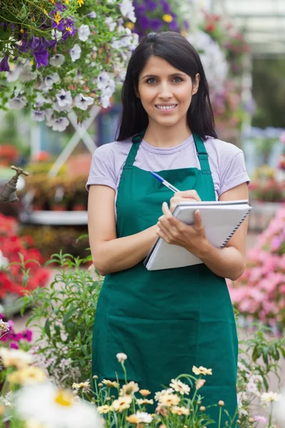 Gardener taking notes in the garden center