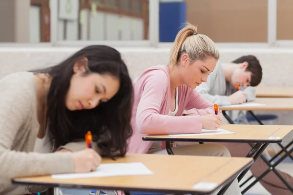 Students writing during an exam