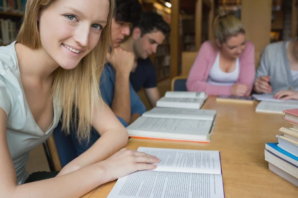 Smiling student with study group — Stock Photo #23102504