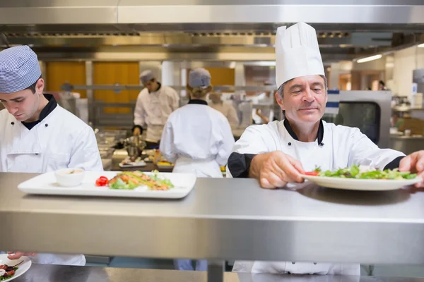 Head chef checking salad