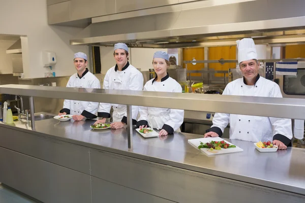 Four happy Chef's in the kitchen