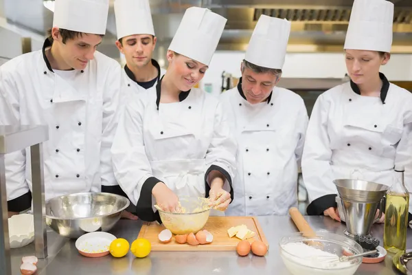 Pastry chef showing students how to prepare dough