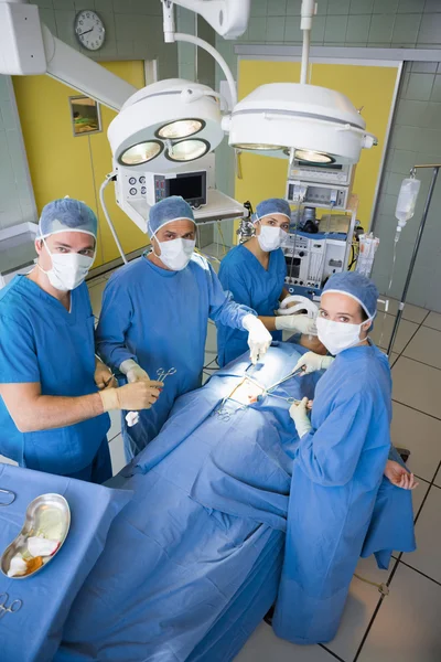 Surgery team looking at camera during operation