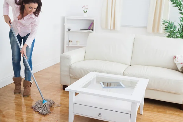 Woman mopping living room floor