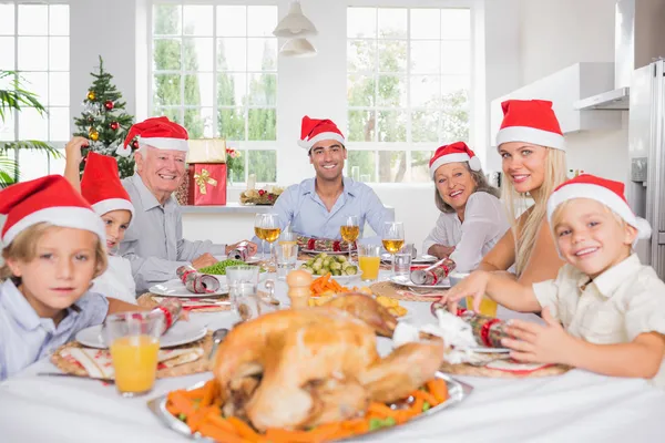 Smiling family around the dinner table at christmas