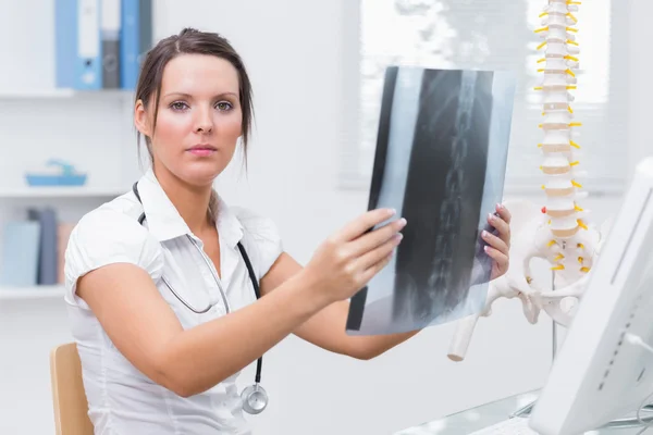 Portrait of female doctor with x-ray at clinic