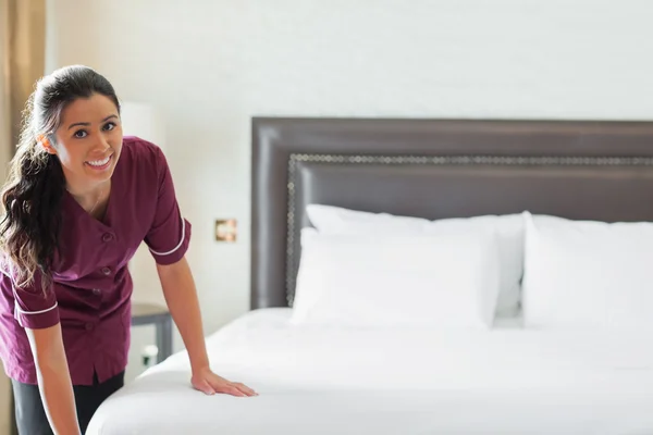 Hotel maid making up the bed