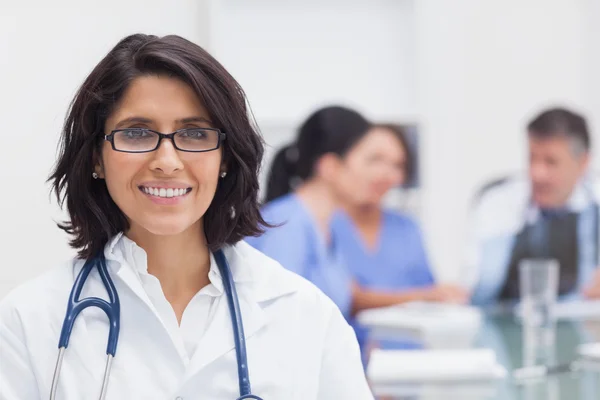 Doctor smiling and her team