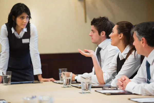 Woman asking question in business meeting