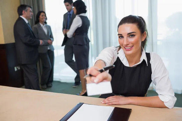 Happy woman handing you a name tag