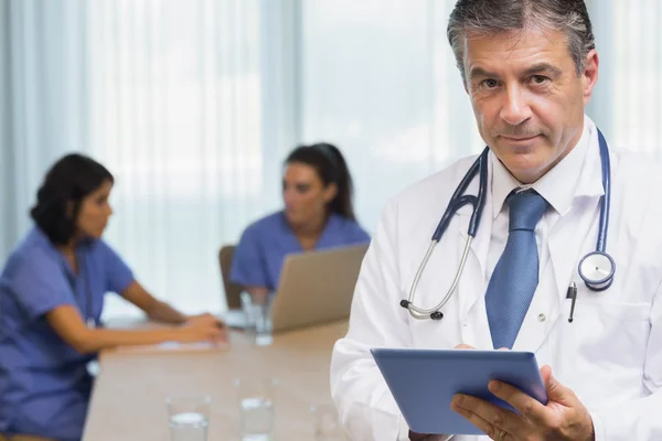 Smiling doctor with tablet