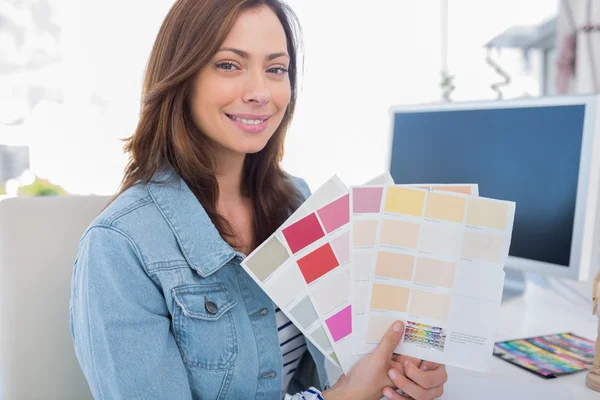 Interior designer holding up colour samples