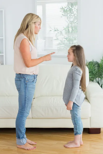 Mother giving out to daughter