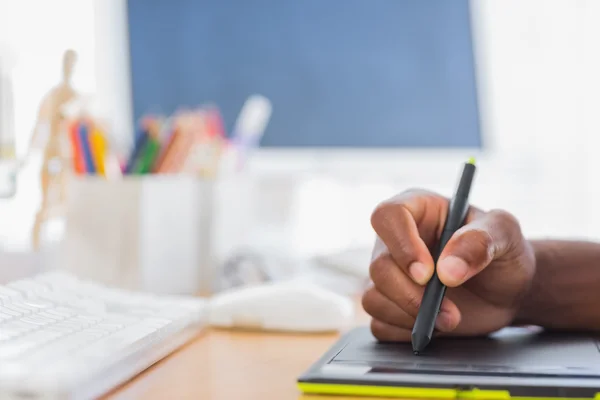 Close up of graphic designer using graphics tablet