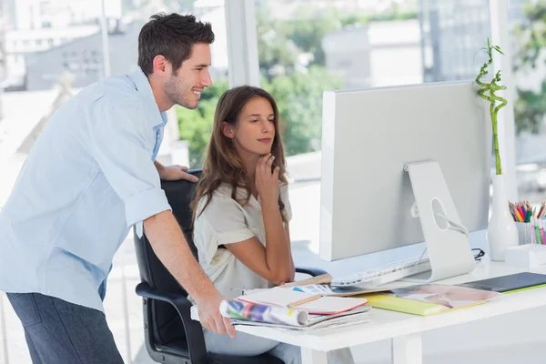 Two photo editors working on their computer