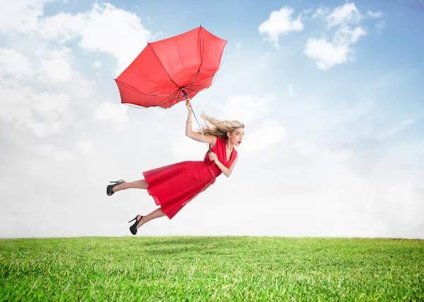 Beautiful woman flying above the grass