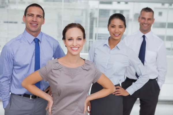 Smiling work team posing together looking at camera