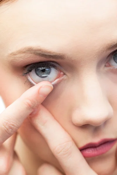 Cute model applying contact lens