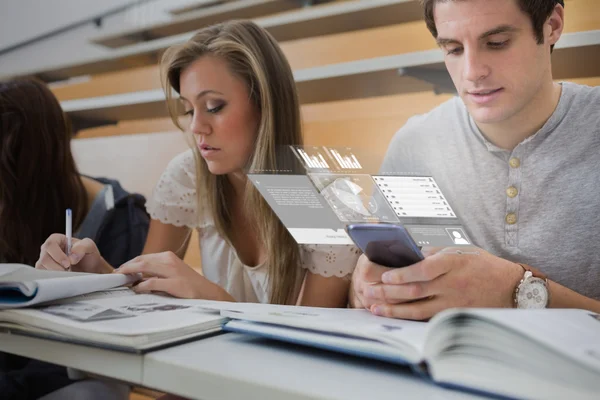 Focused college student working on futuristic smartphone