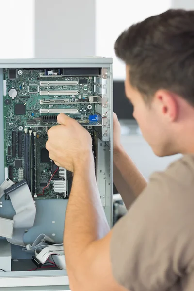 Computer engineer repairing computer