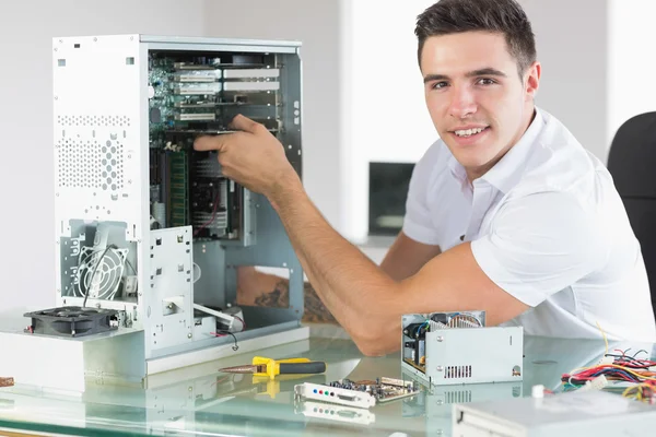 Handsome cheerful computer engineer working at open computer