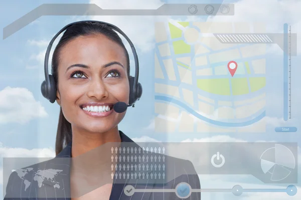 Smiling attractive businesswoman looking at futuristic interface hologram