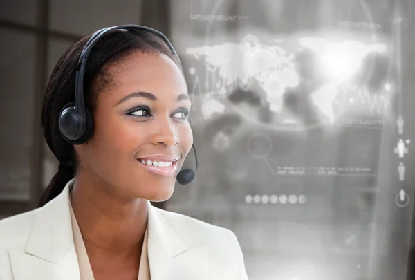 Smiling pretty businesswoman using futuristic interface hologram